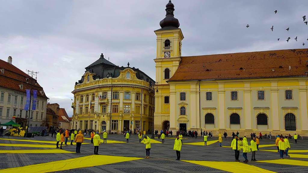 video foto – greenpeace a desenat un soare uriaș în piața mare. mesaj pentru președintele iohannis