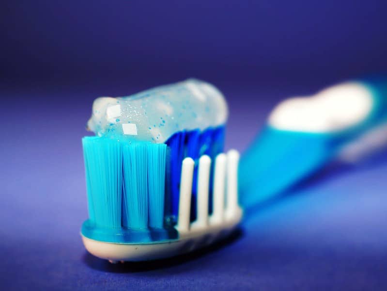 closeup and selective focus photography of toothbrush with toothpaste