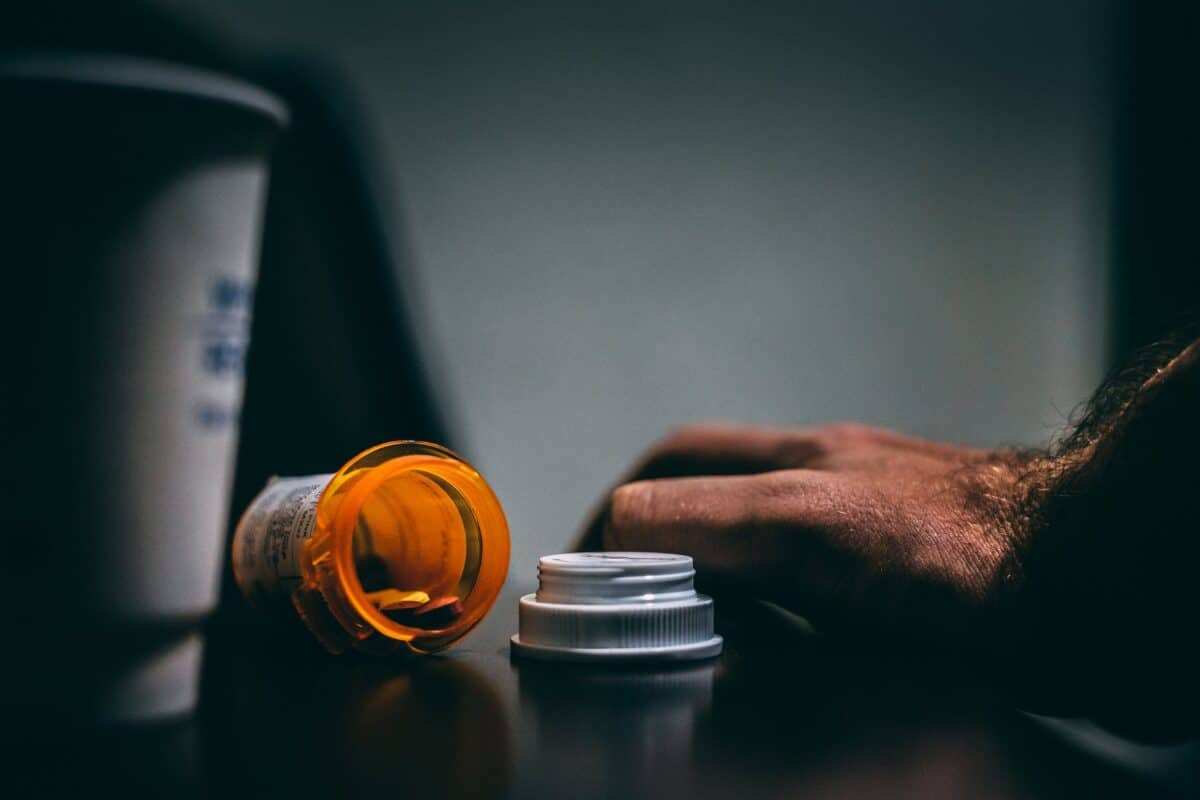 orange and white prescription bottle on table