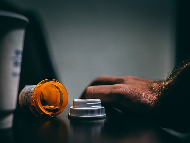 orange and white prescription bottle on table