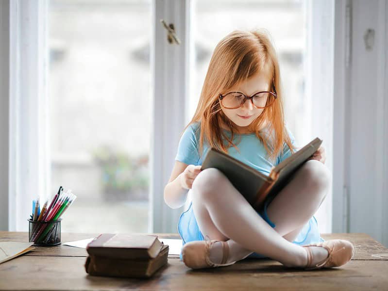 photo of girl reading book