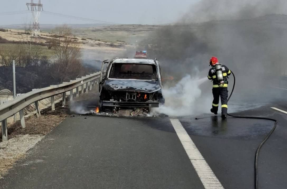 Incendiu pe autostradă în apropiere de Sibiu. Un autoturism mistuit de flăcări și a luat foc și câmpul din apropiere (foto)